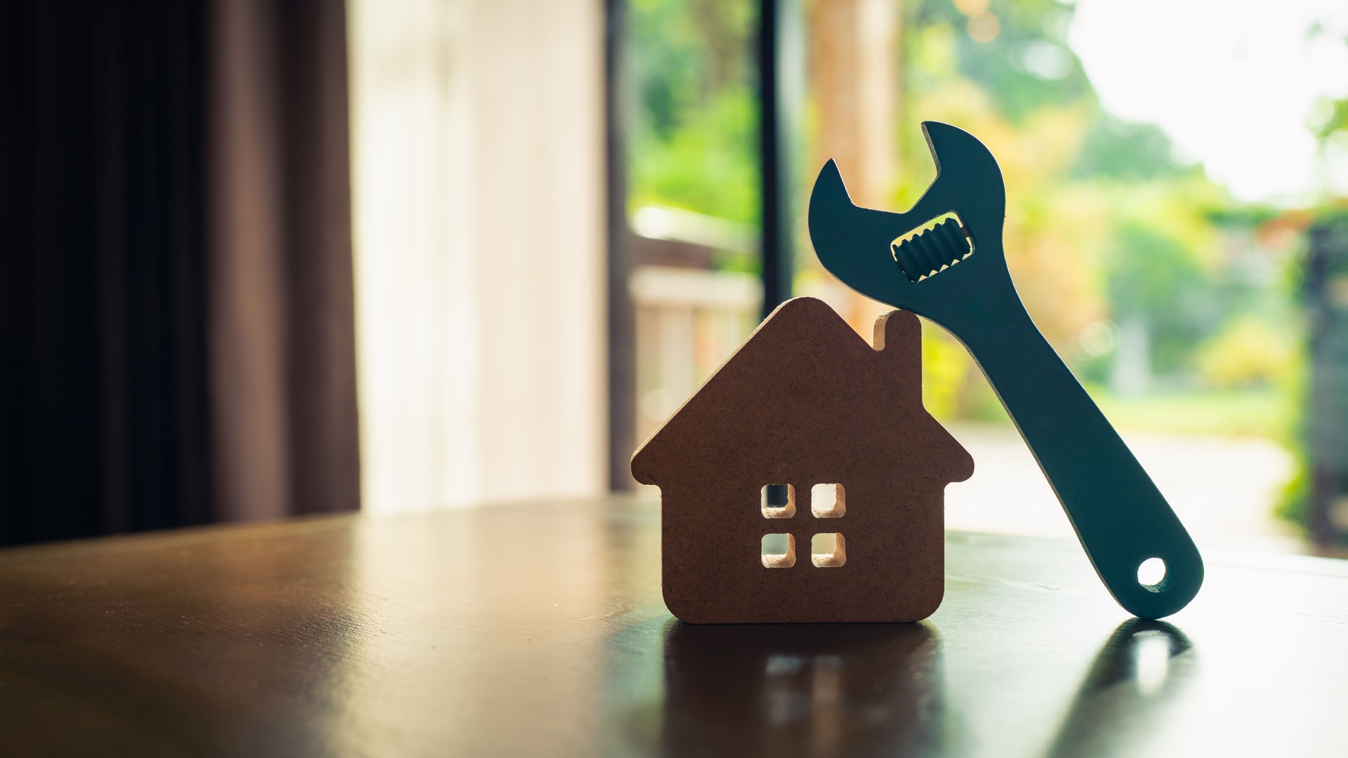 Model house and wrench, home services. Home repairs concept.