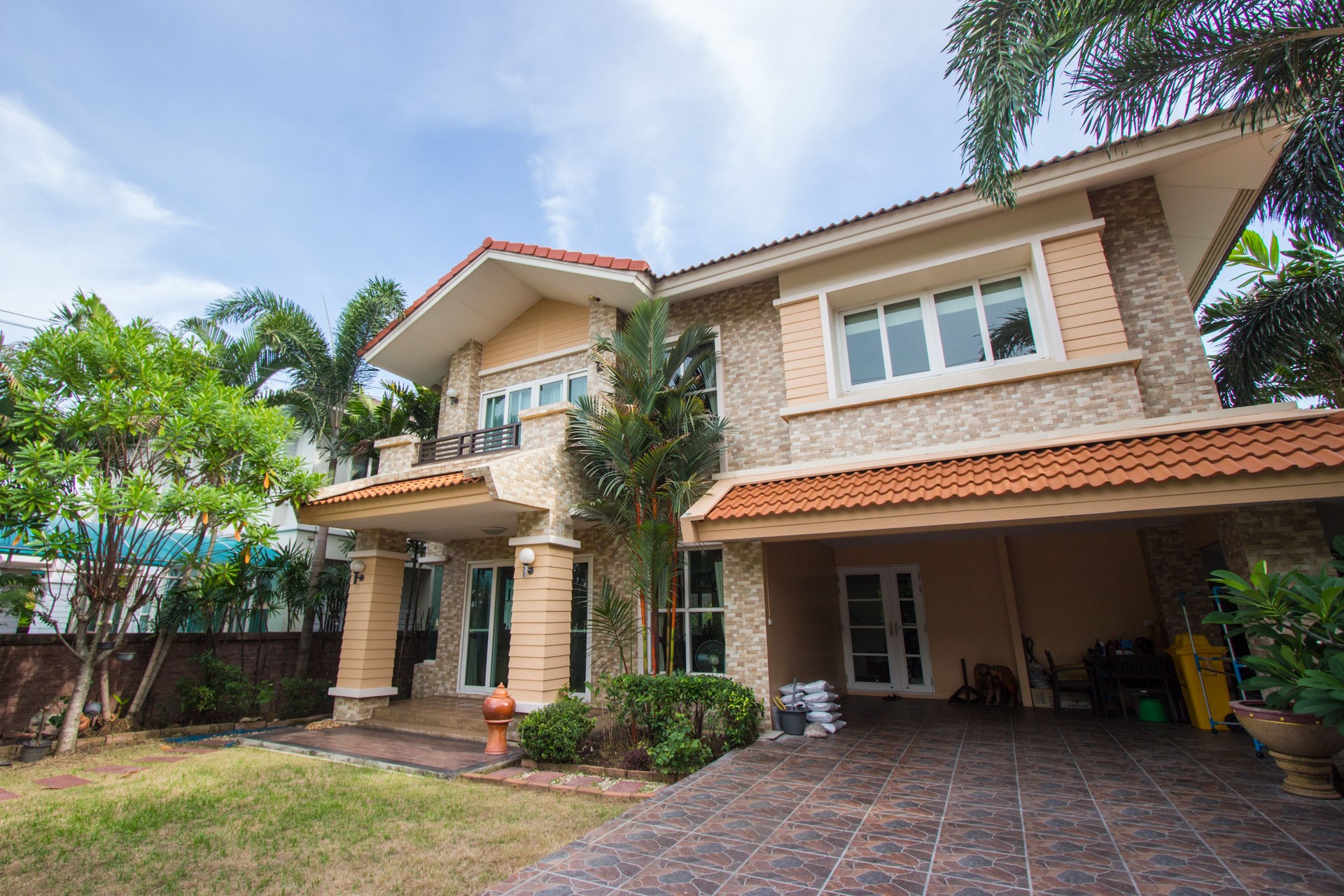House with beautiful landscape on sunny day - Home exterior